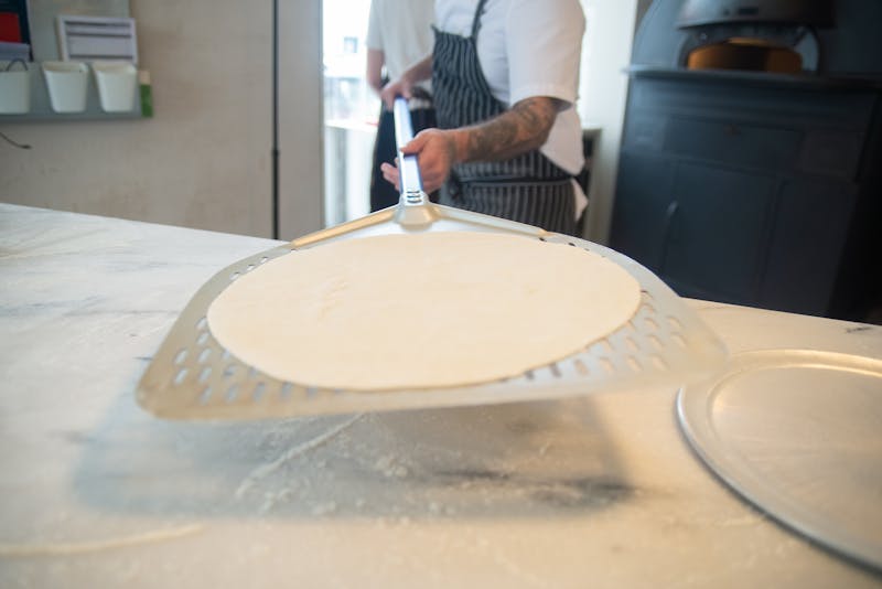 Dewey's Pizza kitchen with fresh ingredients and handcrafted dough